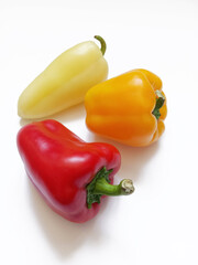 yellow, orange and red peppers on white background
