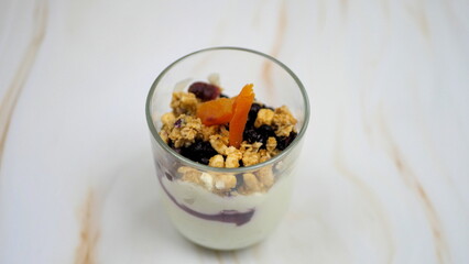 Yogurt with granola, forest fruits and dried apricots