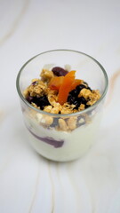 Yogurt with granola, forest fruits and dried apricots