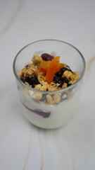Yogurt with granola, forest fruits and dried apricots