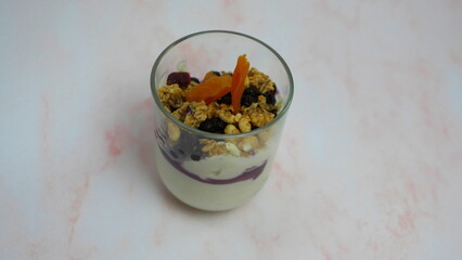 Yogurt with granola, forest fruits and dried apricots