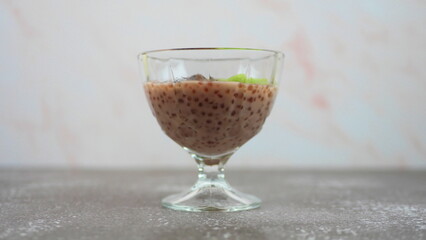 Tapioca dessert with coconut milk and raspberry juice, with the addition of dates and kiwi
