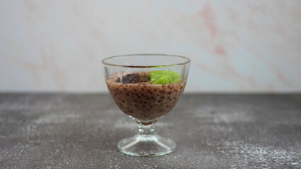 Tapioca dessert with coconut milk and raspberry juice, with the addition of dates and kiwi
