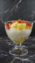 Dessert of tapioca balls with pineapple and mango in an ice cream cup