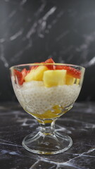 Dessert of tapioca balls with pineapple and mango in an ice cream cup