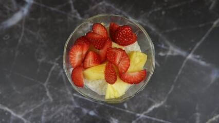 Dessert of tapioca balls with pineapple and mango in an ice cream cup
