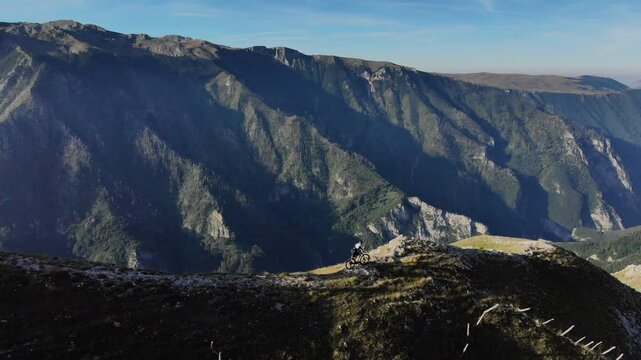 Drone flight over Mountainbiker in the mountains