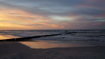 Fototapeta premium Sunset on the beach by the sea