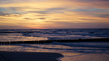 Obraz premium Sunset on the beach by the sea