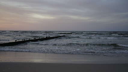 Obraz premium Sunset on the beach by the sea 