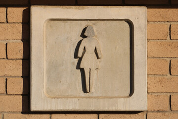 women bathroom stone carving sign