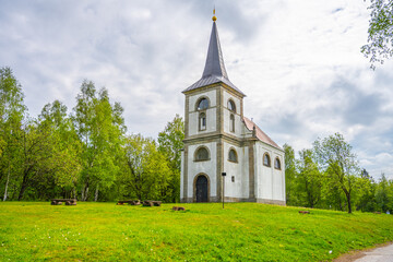 The Church of Saint John of Nepomuk stands proudly on Zvicina Hill, surrounded by lush greenery.