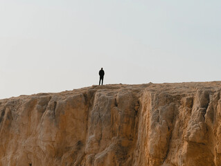 Person standing at the edge of a cliff