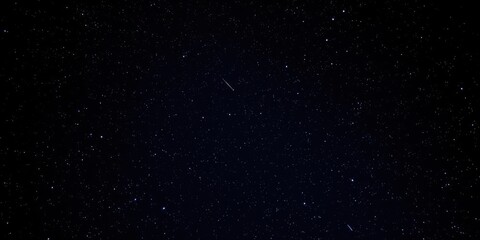 Fototapeta premium Night sky filled with twinkling stars on a dark background, black background, sparkling
