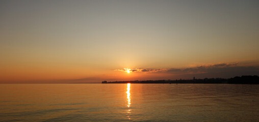 Sunset with the sun reflected on Lake Geneva