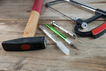 Creative project crafting hand tools jigsaw, knife and drill arranged on workbench, crafting essentials