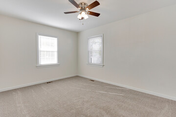 Clean Room With Neutral Walls And Ceiling Fan