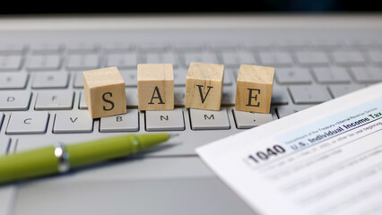 Save text on wooden blocks on a laptop, Concept of tax filing through e file.