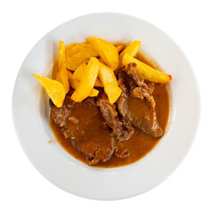 There is hot lunch on tablecloth of table. Juicy veal beef tenderloin stew in wine sauce gravy and garnished with fried potato slices. Dish decorated with chopped edible green. Isolated over white
