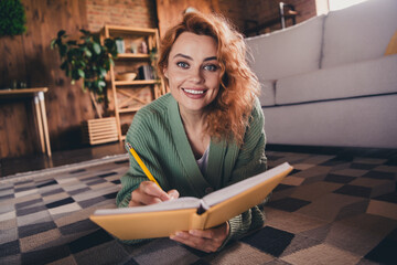 Photo of adorable sweet lady wear green cardigan writing diary indoors room home house