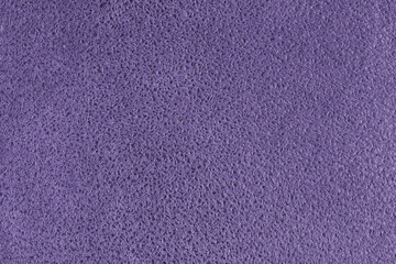 Purple suede leather texture with embossed shabby spotted pattern. Structure of fleecy cloth surface, decorative upholstery fabric, home decor and garment. Wallpaper, background, backdrop.