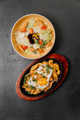 Sizzling skillet breakfast with eggs and potatoes paired with a fresh salad for a balanced meal