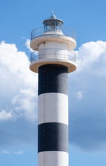 close-up of a lighthouse with a background of clouds