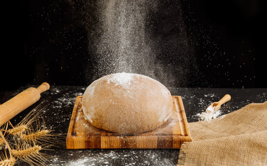 Rustic bread with flour sprinkling in motion, symbolizing the art of traditional baking