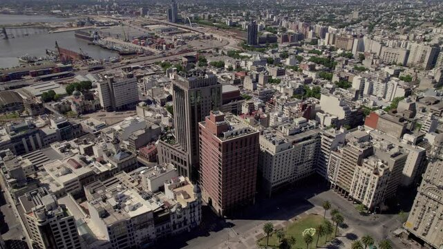 The independence Square of Montevideo with urban buildings, with a background of the port in Uruguay