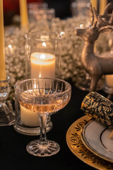 Champagne glass on Christmas Table. Holiday decoration