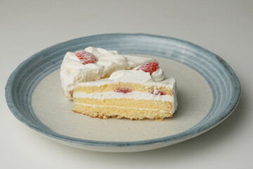 Two Japanese strawberry shortcakes on a stylish large plate on a white table