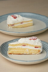 Japanese strawberry shortcake on each stylish large and small plate on a wooden table