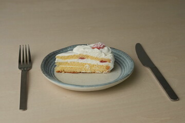 Japanese strawberry shortcake on a stylish large plate on a wooden table