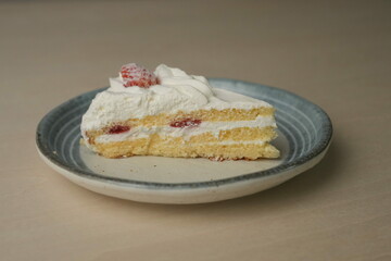 Japanese strawberry shortcake on a stylish large plate on a wooden table