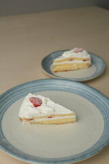 Japanese strawberry shortcake on each stylish large and small plate on a wooden table