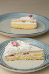 Japanese strawberry shortcake on each stylish large and small plate on a wooden table