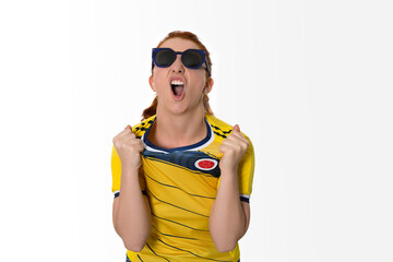 Excited Female Soccer Fan in Colombian Jersey Pulling Shirt and Shouting with Joy, Wearing Sunglasses, Expressing Passionate Emotion on White Background, Celebrating Football Victory with Enthusiasm