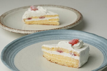 Two Japanese strawberry shortcakes on a stylish large plate on a white table