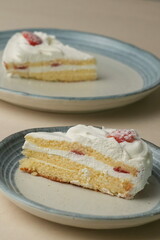 Japanese strawberry shortcake on each stylish large and small plate on a wooden table