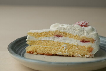 Japanese strawberry shortcake on each stylish large and small plate on a wooden table