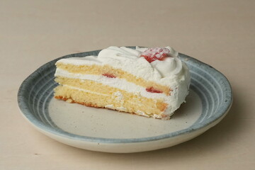 Japanese strawberry shortcake on each stylish large and small plate on a wooden table