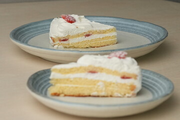 Japanese strawberry shortcake on each stylish large and small plate on a wooden table