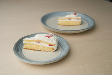 Japanese strawberry shortcake on each stylish large and small plate on a wooden table