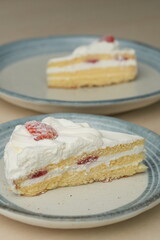 Japanese strawberry shortcake on each stylish large and small plate on a wooden table