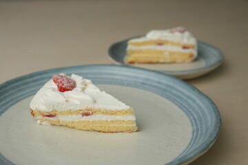 Japanese strawberry shortcake on each stylish large and small plate on a wooden table