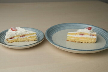 Japanese strawberry shortcake on each stylish large and small plate on a wooden table