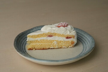 Japanese strawberry shortcake on a stylish large plate on a wooden table