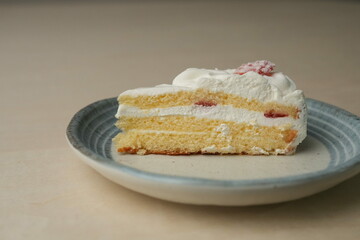 Japanese strawberry shortcake on a stylish large plate on a wooden table
