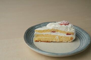 Japanese strawberry shortcake on a stylish large plate on a wooden table