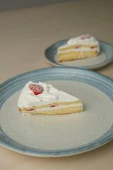 Japanese strawberry shortcake on each stylish large and small plate on a wooden table